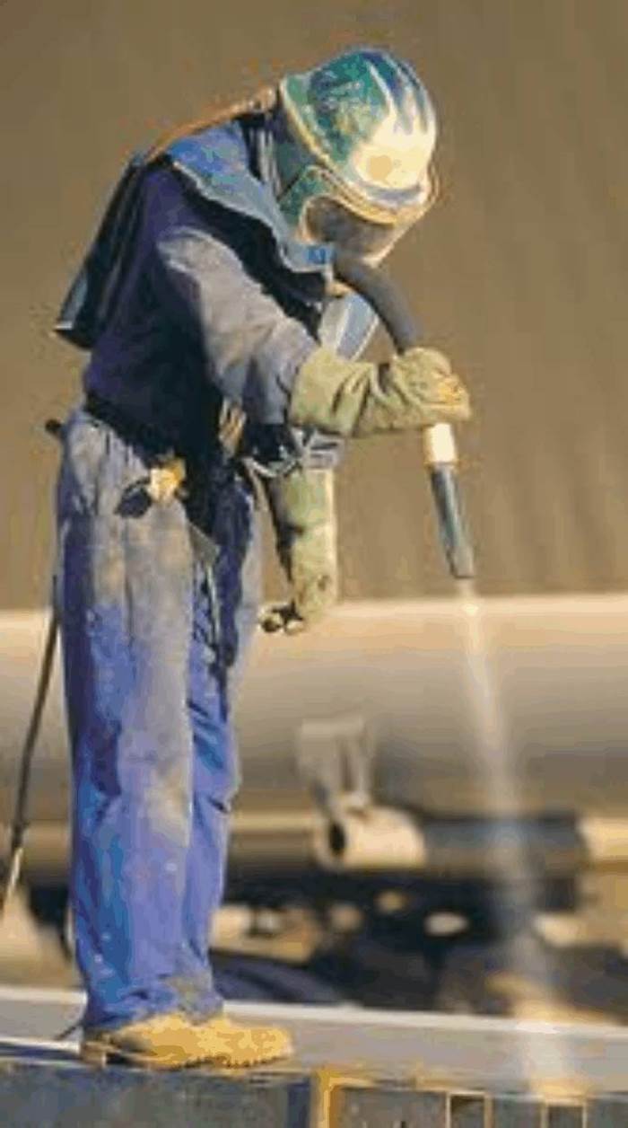 Lavoratore mentre effettua la sabbiatura
